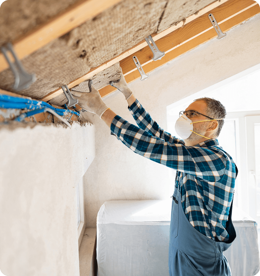 A professional performing insulation installation at a client's attic.