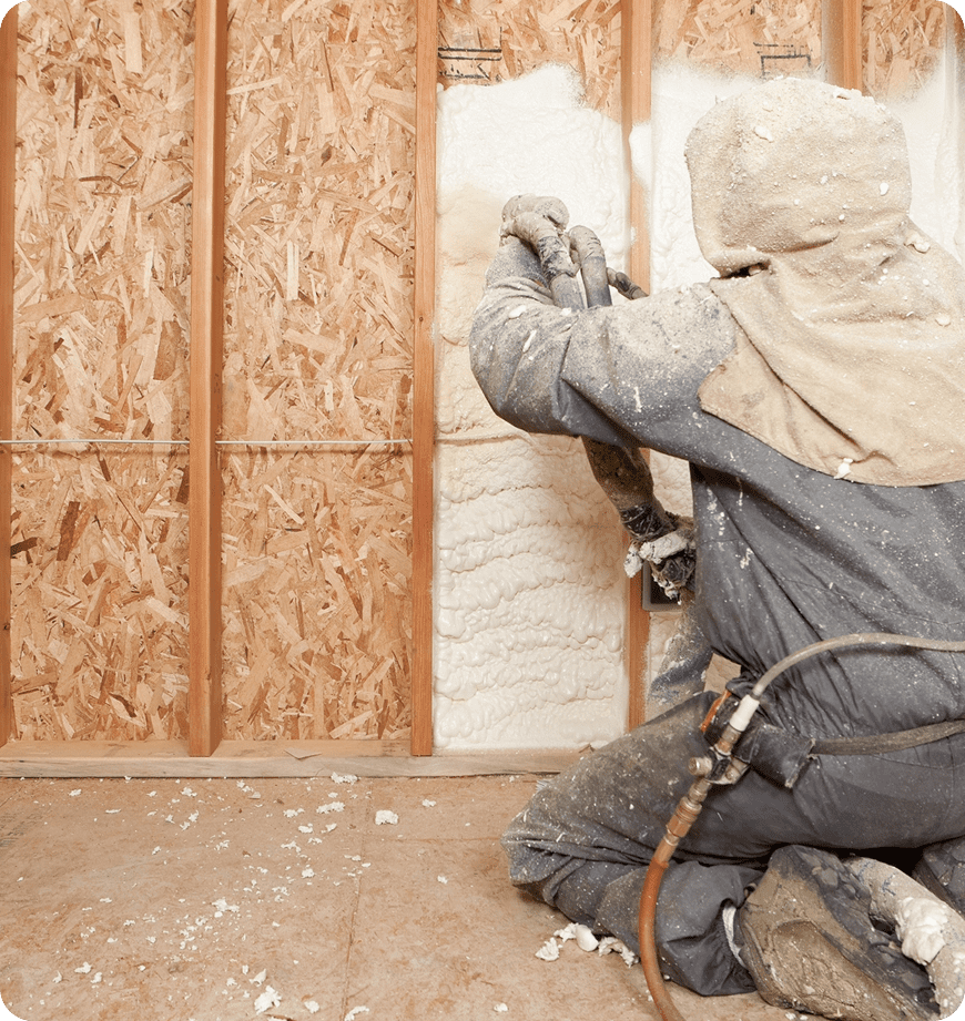 A technician performing a professional spray foam insulation installation inside a wall.