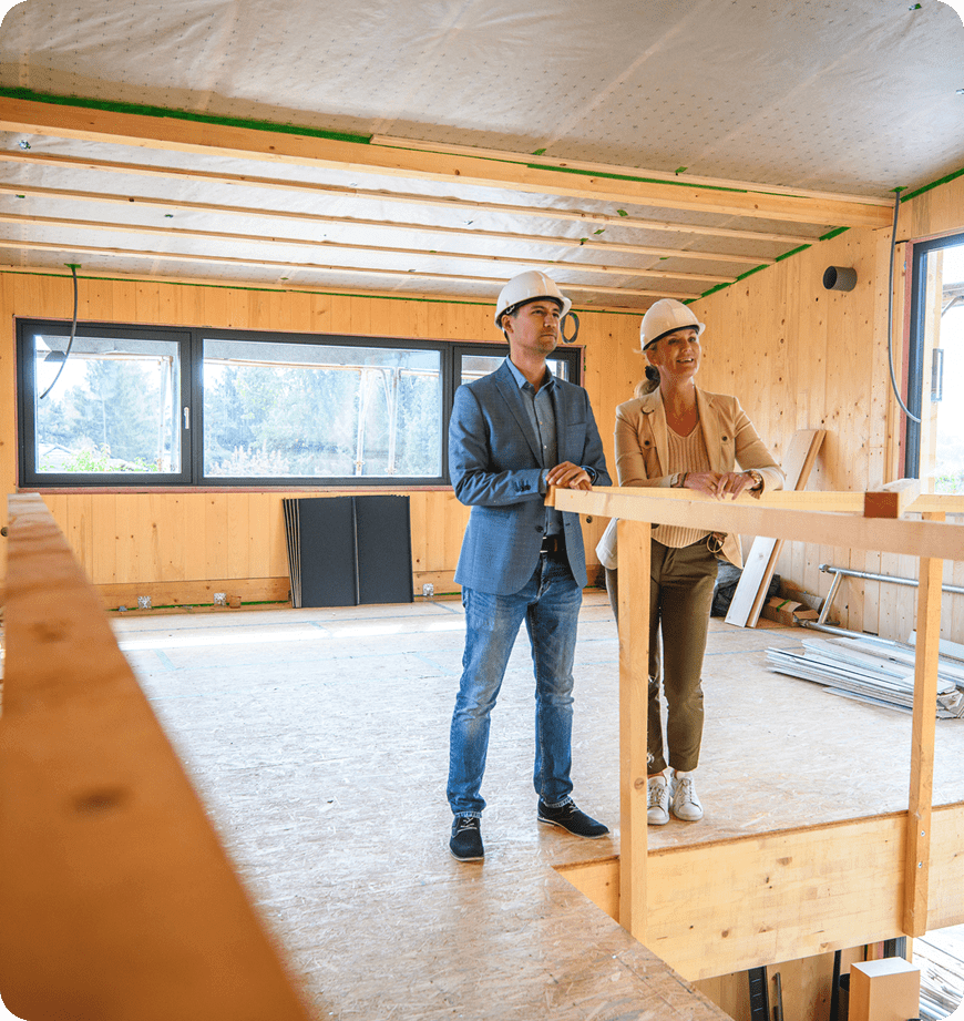 People inspecting an insulation installation with hard hats.