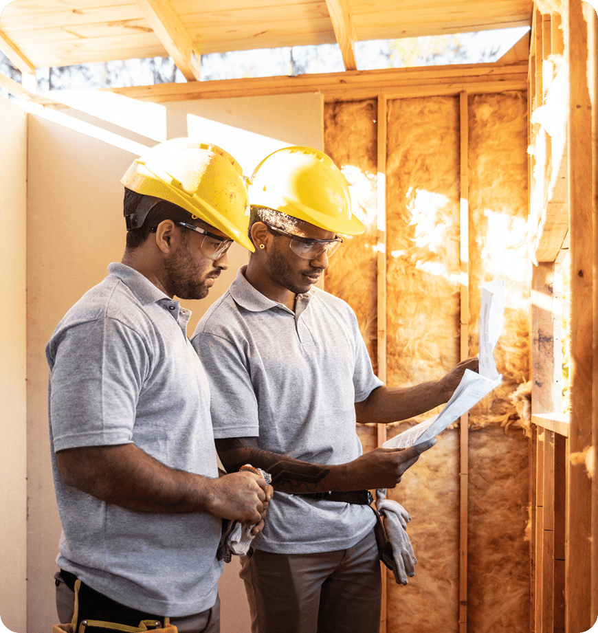 Construction worker reviewing a home energy evaluation plan.