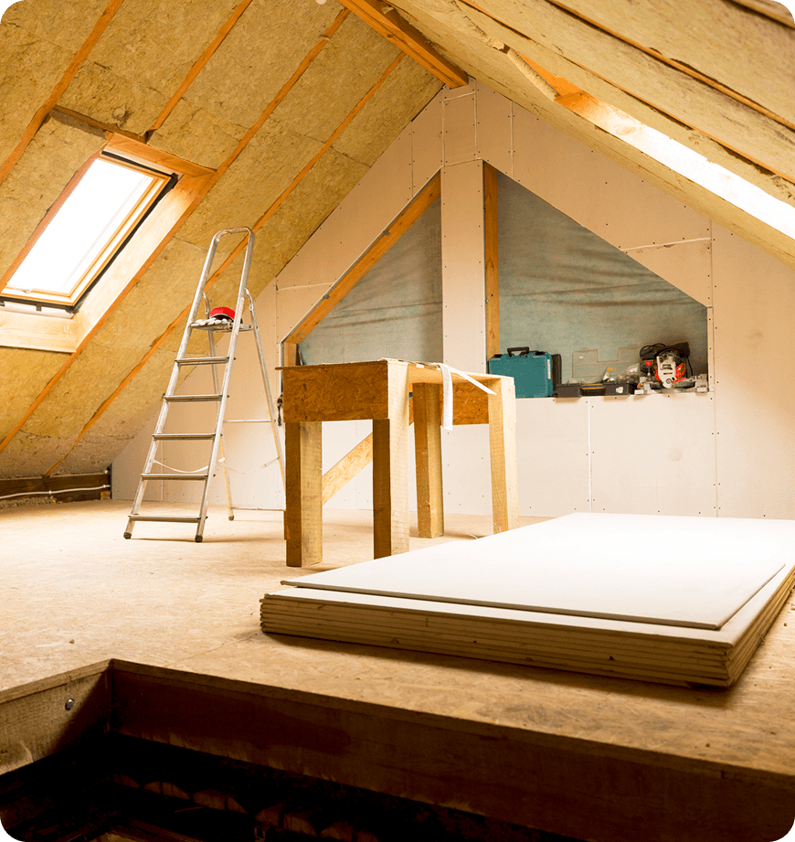 Attic insulation installation with workbench and ladder.