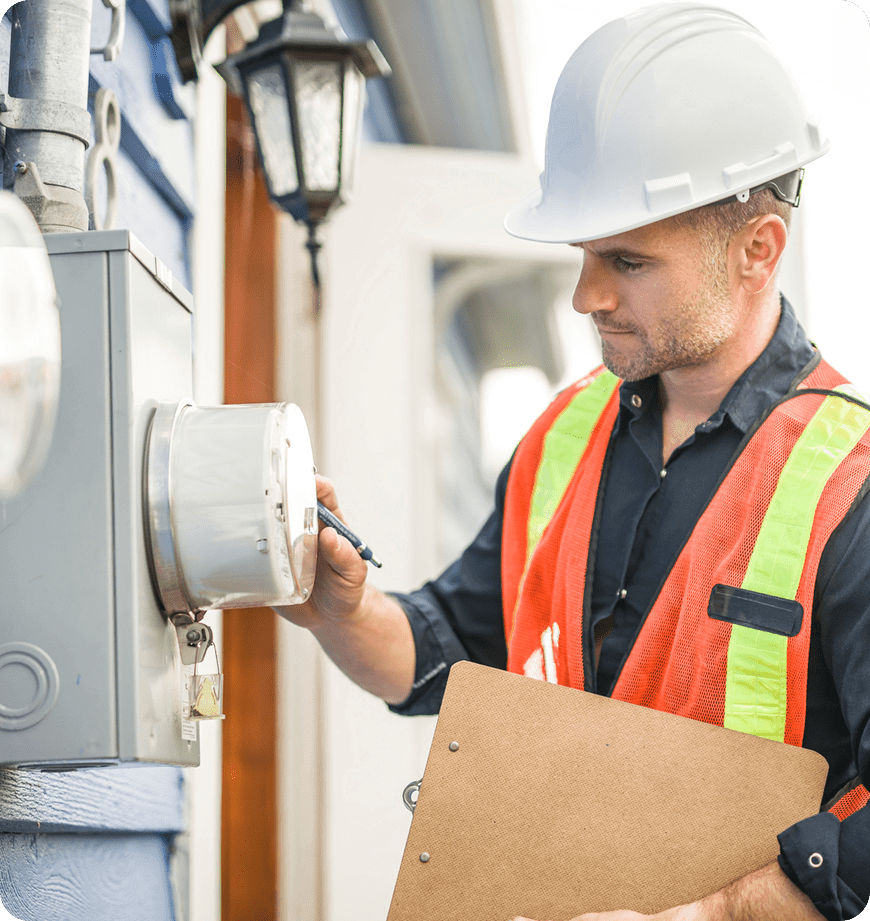 Technician inspecting electrical meter for energy saving upgrades in Eugene, OR.