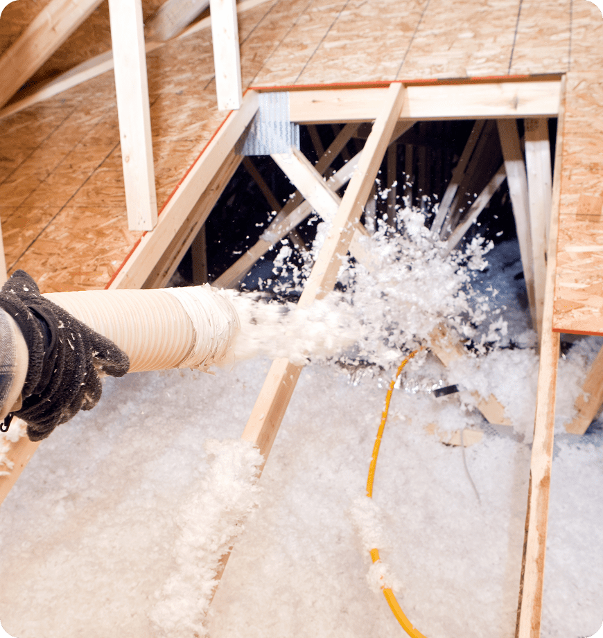 A specialist spraying cellulose insulation during an in-house visit.