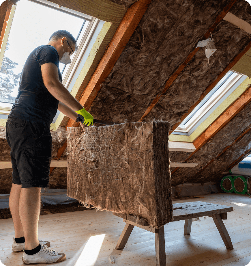 A man performing attic insulation installation for a residential property in Eugene, OR.