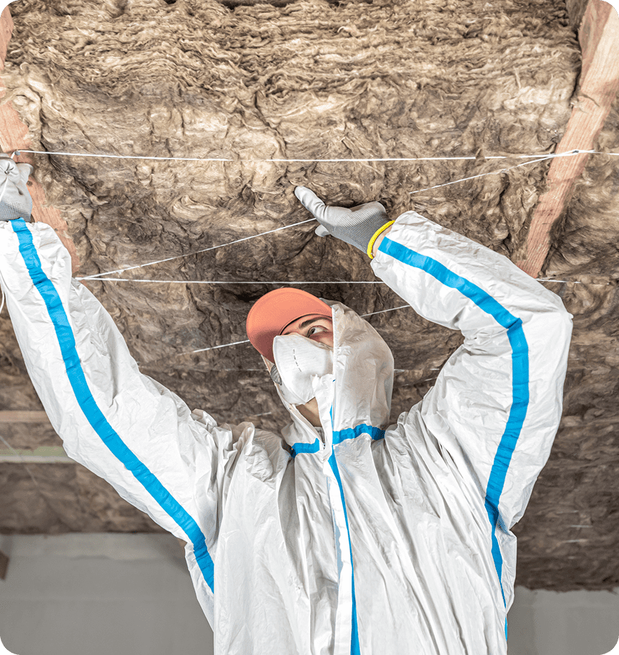 A man in protective gear completing insulation removal and replacement in Eugene, OR.