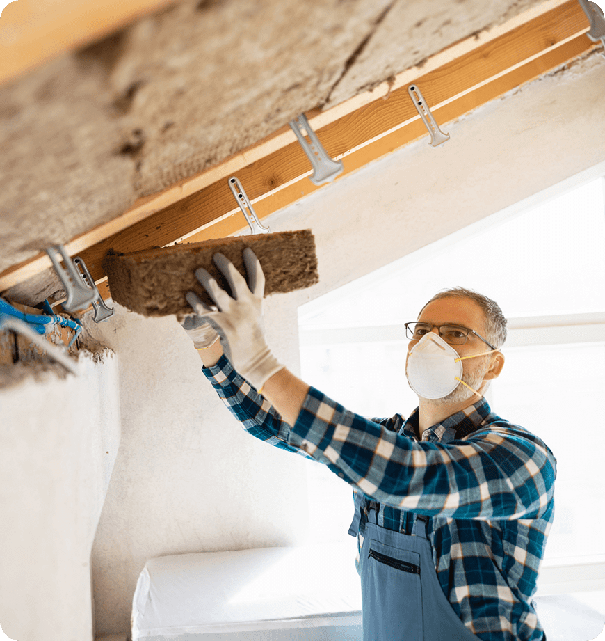 A professional performing SuperAttic insulation at a client's attic.