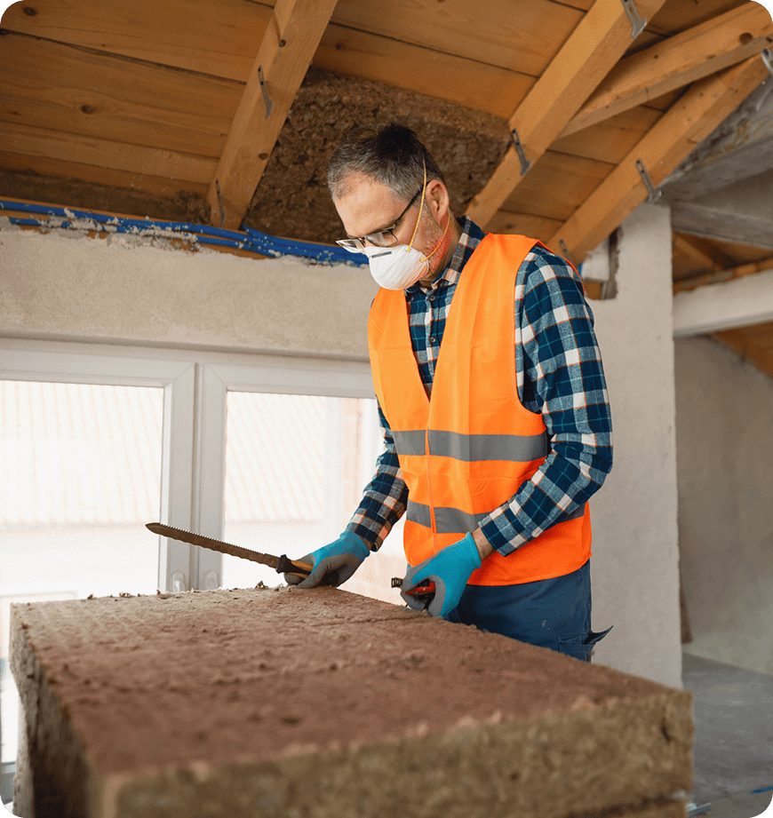 A professional inspecting an insulation installation in the attic.