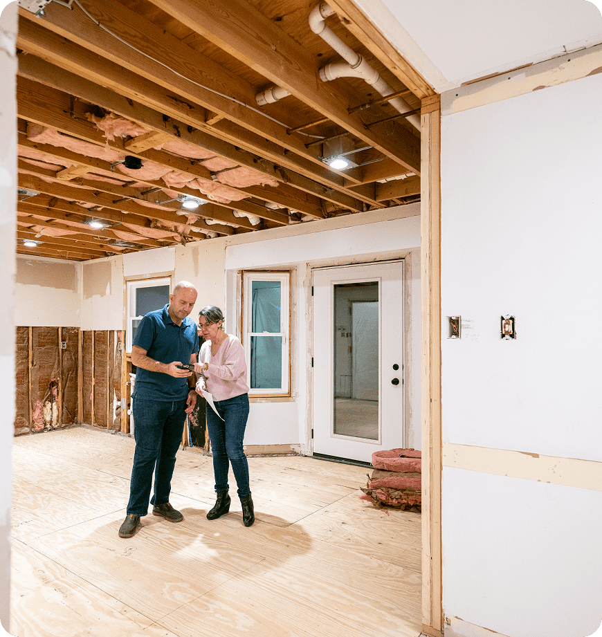 Two people inspecting a home renovation project.