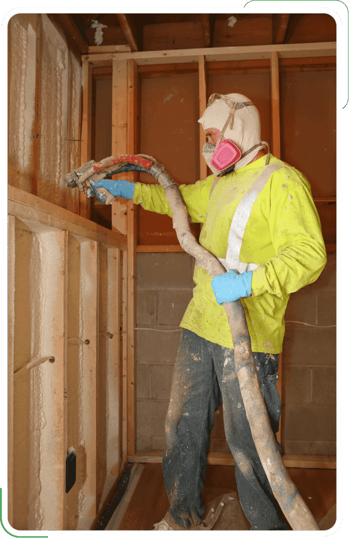 A professional in Eugene applying foam insulation to a wall cavity
