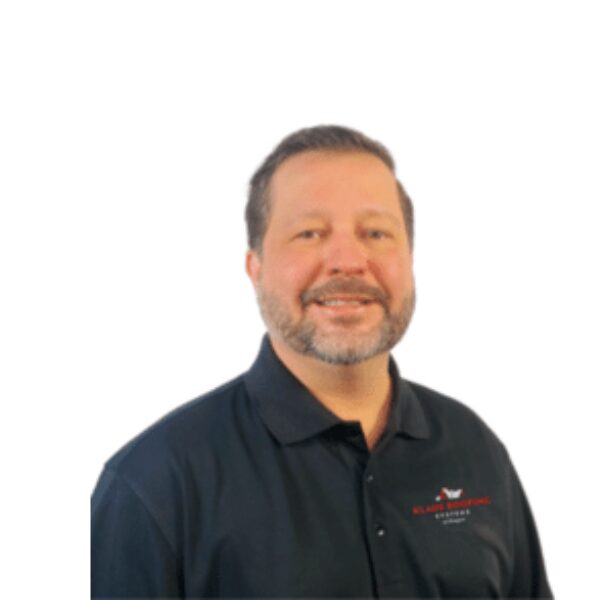 Smiling man in a black polo shirt.